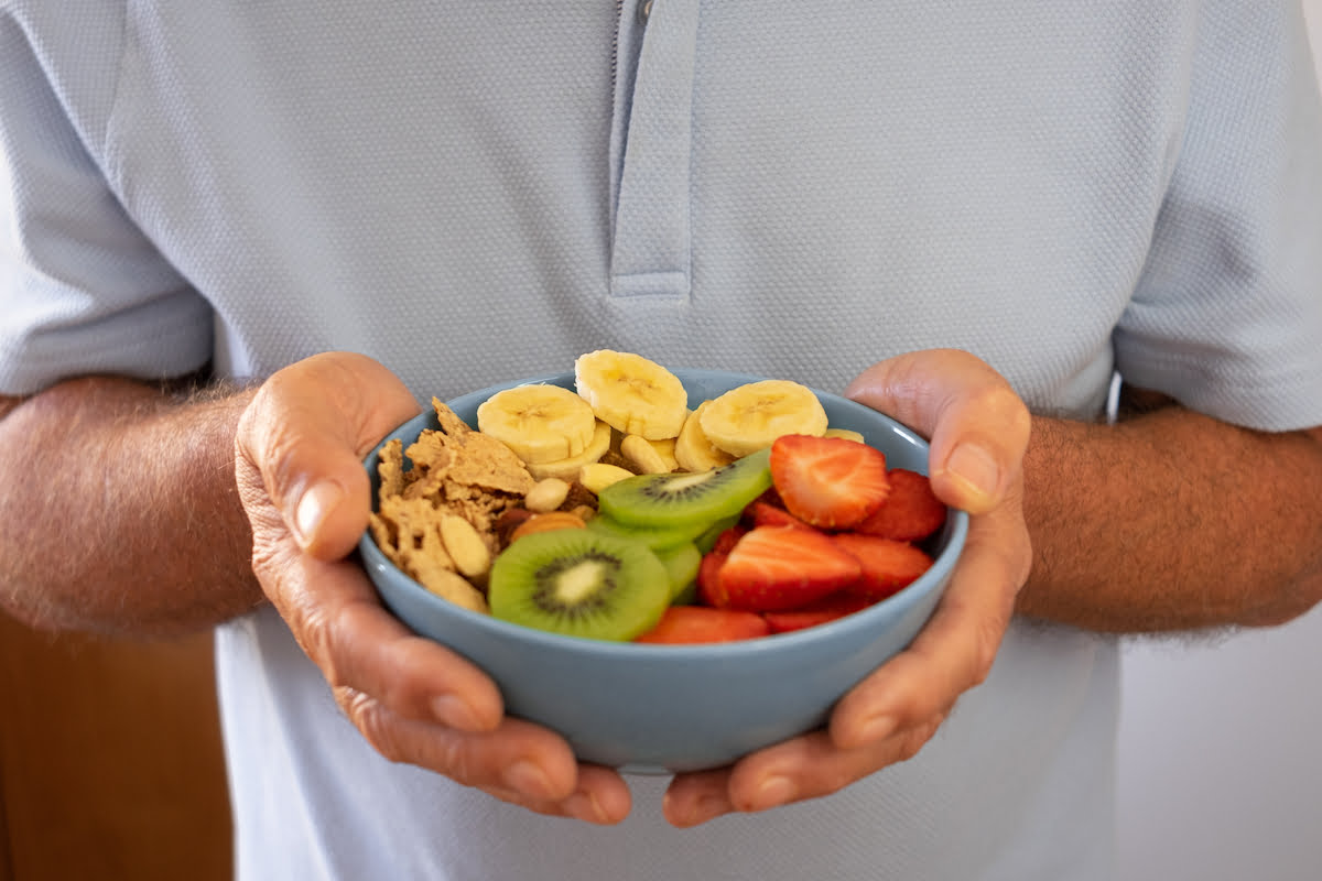 Senior Man Holding Bowl of Cereal and Fruit_The Pavilion Senior Living